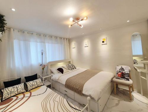a bedroom with a large bed and a window at Maison Stay in Samgong