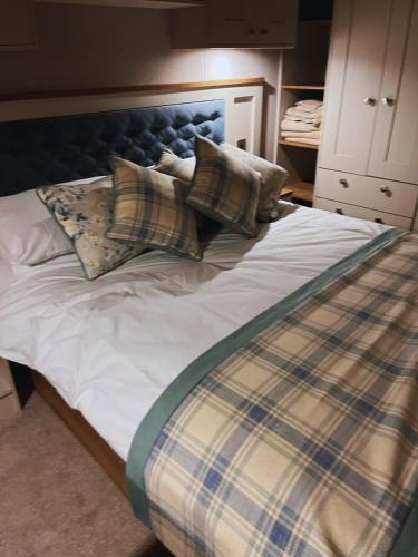 a bed with pillows on it in a bedroom at St Minver Hideaway in Saint Minver