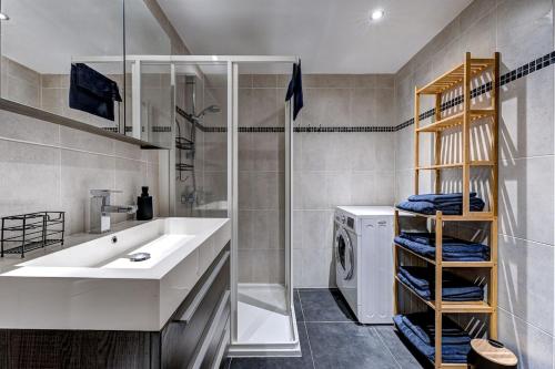 a bathroom with a sink and a washing machine at Tiny Chalet - near to Servoz train station in Les Houches