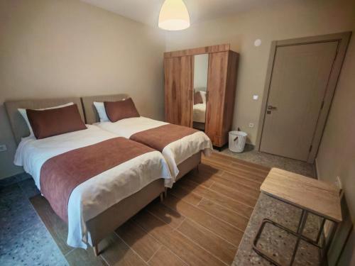 a bedroom with a large bed and a mirror at Suitev in Arnavutköy