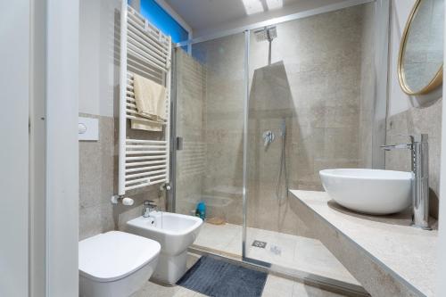 a bathroom with a toilet and a sink and a shower at La casa di Aurora in Pavia