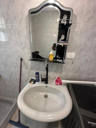 a white sink in a bathroom with a mirror at ريفيرا 1 in Ras Sedr