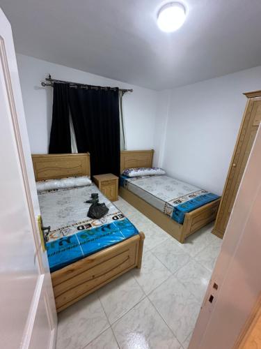 a room with two beds and a window at ريفيرا 1 in Ras Sedr