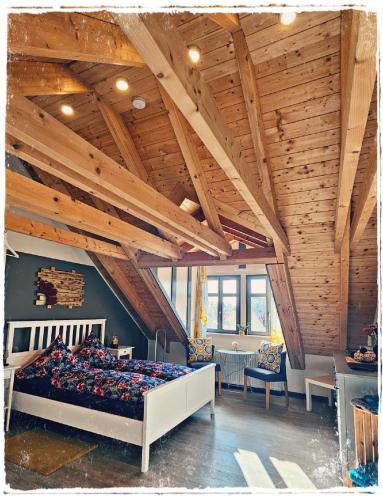 a bedroom with a large bed in a room with wooden ceilings at Gästehaus am Stadttor in Naumburg