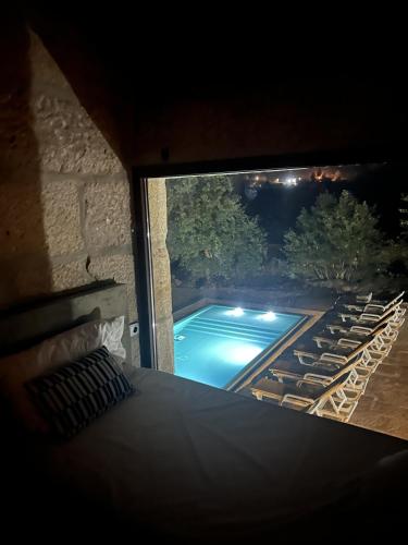 a view of a swimming pool outside a window at Casa da eira in Santo Emilião