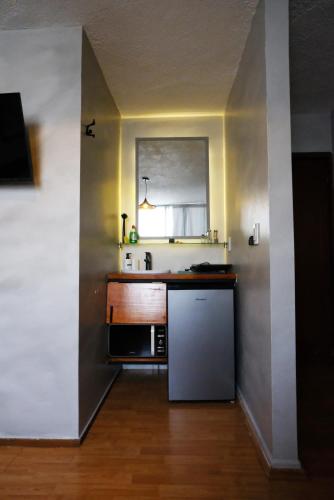 a kitchen with a sink and a refrigerator at Compact Studio Apartment Casa Icacos Apt 6 in Mexico City