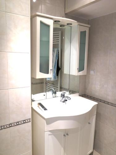 a bathroom with a white sink and a mirror at The Red Konak in Veliko Tŭrnovo