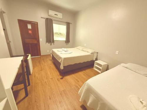 a small room with two beds and a window at Mindú Park Hotel in Manaus