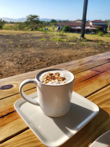 a cup of coffee sitting on a plate on a table at Santa Catalina Surf Studios- Ocean Adventures in Santa Catalina