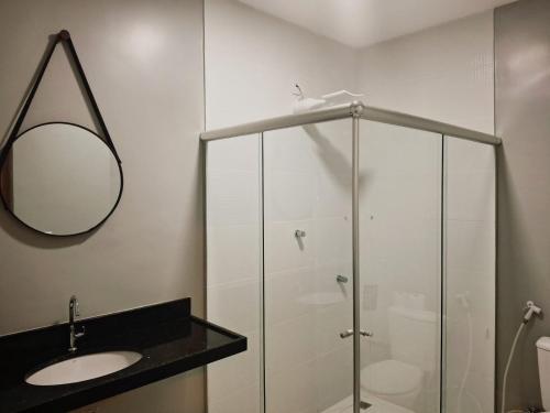 a bathroom with a glass shower and a sink at Mindú Park Hotel in Manaus