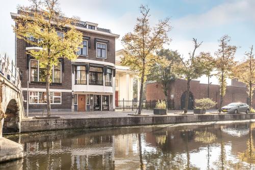 a rendering of a building next to a river at BizStay Delft in Delft