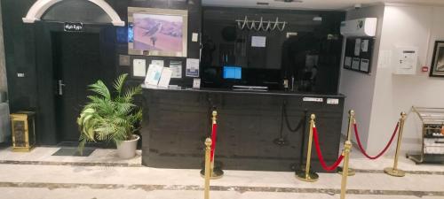 a room with two red ropes and a counter at Saad in Cairo