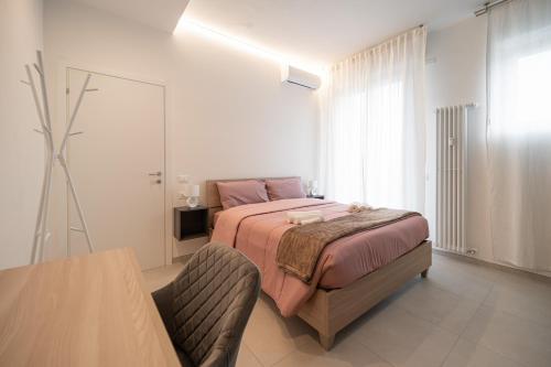 a bedroom with a bed and a table in it at Alloggio Viola - Gionic Apartments Bologna in Bologna