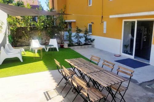 a patio with a wooden table and chairs at What else guest house in Fátima