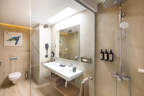 a bathroom with a sink and a shower at Riu Ventura - All Inclusive in Cancún