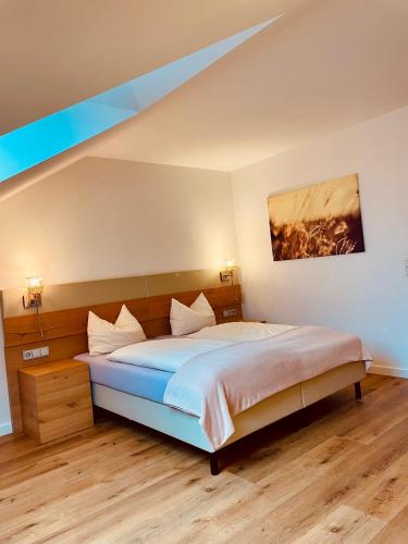 a bedroom with a bed and a painting on the wall at Brandmayerhof in Oberding