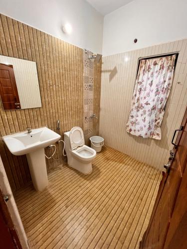 a bathroom with a sink and a toilet at Jamath Villas 1307 in Kīlakarai