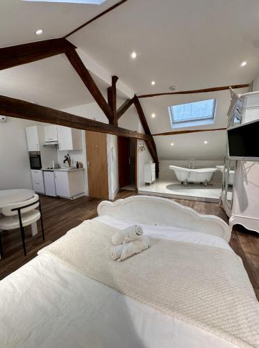 a bedroom with a bed with a teddy bear on it at Studio 3 des Remparts à 5 mins de Charleville-Mézières in Warcq