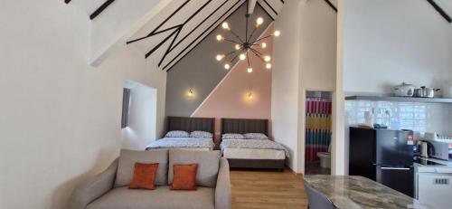 a living room with two beds and a couch in it at B661 SilverparkResort -walk up in Bukit Fraser