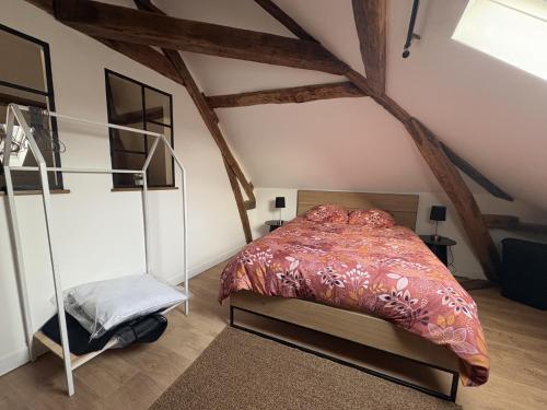 a bedroom with a bed in a attic at Rustique Chic proche centre-ville in Clermont