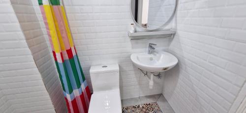 a bathroom with a sink and a toilet and a mirror at B661 SilverparkResort -walk up in Bukit Fraser