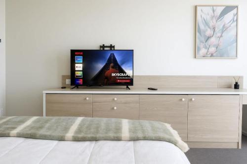 a bedroom with a tv on top of a dresser at L19 Ocean View Suite - King Bed Wi-Fi in Gold Coast