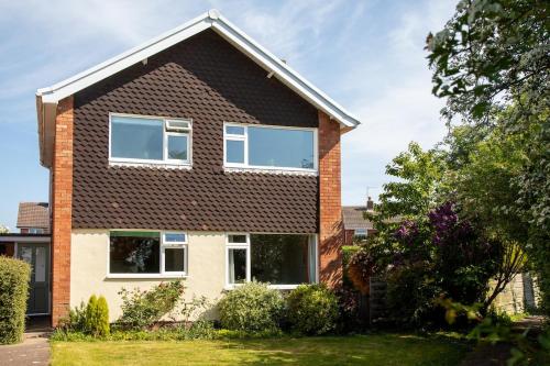 a house with a brown roof at Hereford Long Term Comfortable Accommodation, 4 bedrooms with Parking in Hereford