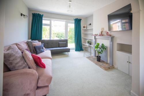 a living room with a couch and a fireplace at Hereford Long Term Comfortable Accommodation, 4 bedrooms with Parking in Hereford