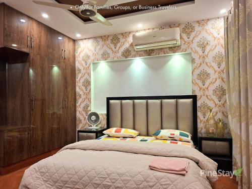 a bedroom with a large bed in a room at Pine Stay Premium 3 Bedroom Furnished Family Home in Lahore