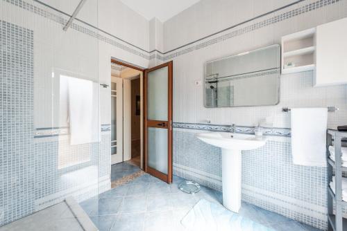 a bathroom with a sink and a mirror at The Old-Clock Apartment by PikHost in Shkodër