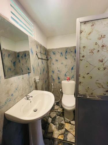 a bathroom with a sink and a toilet at Elephant Cabana Udawalawe in Udawalawe