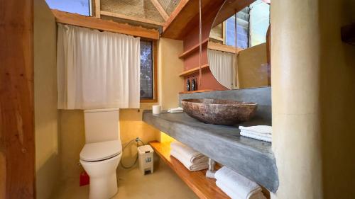 a bathroom with a bowl sink and a toilet at Lions Eco Resort & Spa in Malindi
