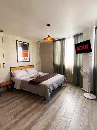 a bedroom with a bed and a sign that reads respawn at Comfortable Studio Apartment Casa Icacos Apt 7 in Mexico City
