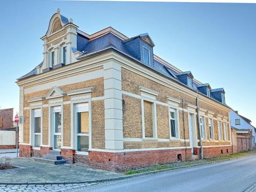 a large brick building on the side of a street at GurkenLoft in Lübbenau