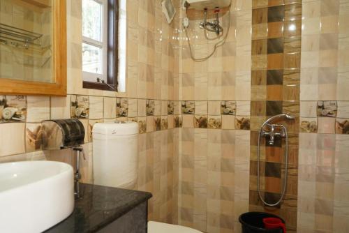 a bathroom with a sink and a shower at Bethany Homestay in Kalimpong