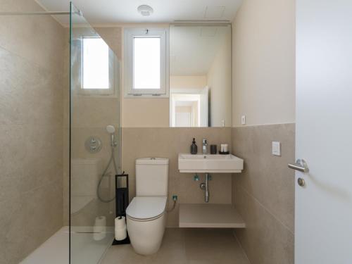 a bathroom with a toilet and a sink and a shower at Salobre Golf Villas Kaiman in Salobre