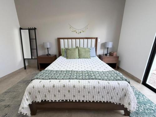 a bedroom with a large bed and two night stands at Residencial en San Miguel de Allende in San Miguel de Allende