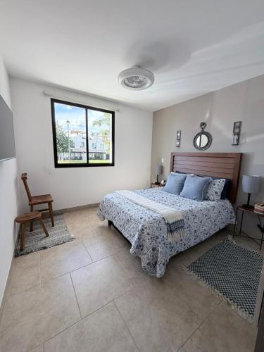 a bedroom with a bed and a chair and a window at Residencial en San Miguel de Allende in San Miguel de Allende