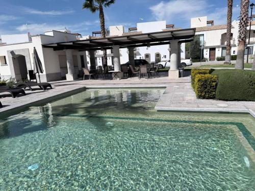 a swimming pool in front of a house at Residencial en San Miguel de Allende in San Miguel de Allende