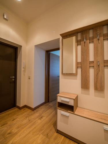 a kitchen with a sink and a mirror at AmberHome in Liepāja