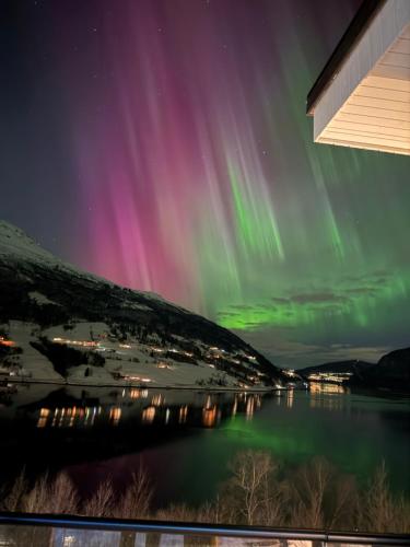 a view of the aurora borealis over a lake at Sea Front Olden in Olden