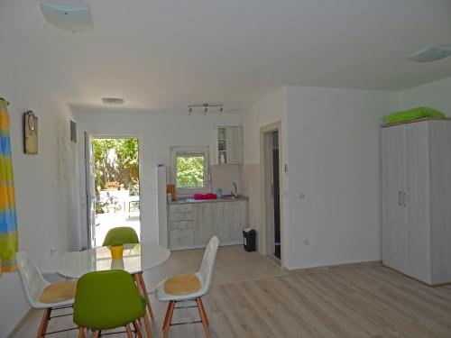 a kitchen and dining room with a table and chairs at Apartment Anja in Tivat