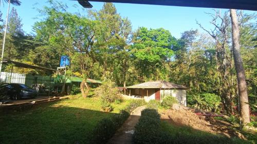 a view of a yard with a small house at Ecotropicfarmhouse in Cerro Azul