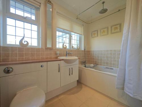 a bathroom with a toilet and a sink and a tub at 2 Bed in Brighstone oc-n30464 in Brighstone