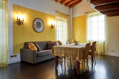 a living room with a table and a couch at P&P Piazza Bergamo Apartment in Bergamo