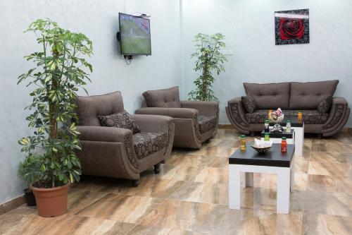 a living room with two couches and a table at Qsr Al Lolo in Sakakah