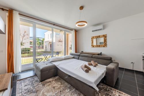 a living room with a couch and a large window at Blue Haven Talea by PikHost in Tale