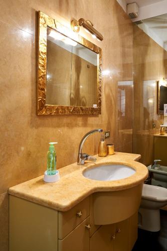 a bathroom with a sink and a mirror at P&P Piazza Bergamo Apartment in Bergamo