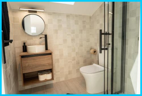 a bathroom with a toilet and a mirror at Peniche Surf Lodge 2 in Peniche