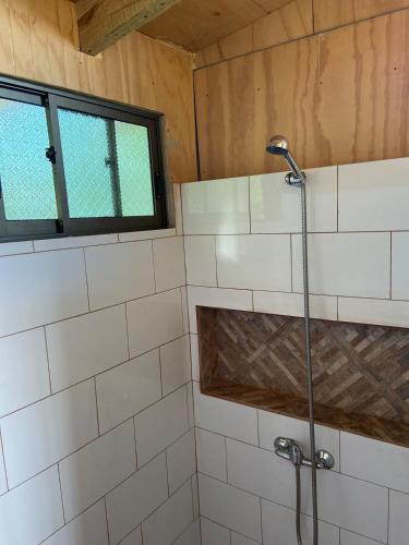 a shower in a bathroom with a window at Studio Sunset Rapa Nui in Hanga Roa